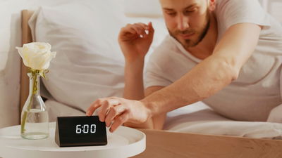 Man Using Smart Alarm Clock Wake Up