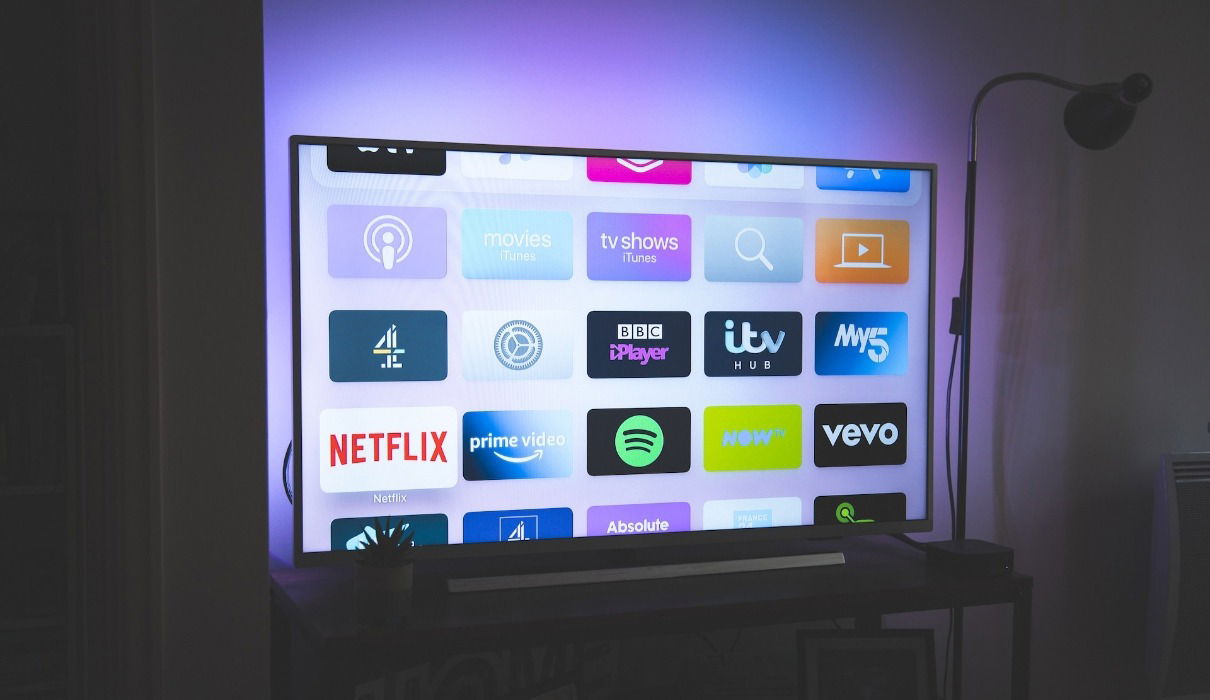 Large 4K TV turned on showing icons for streaming apps