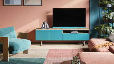 Living room TV setup with blue and pink themed furniture
