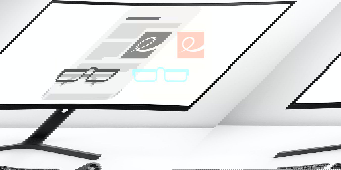 A photograph of a monitor in front of a white wall.