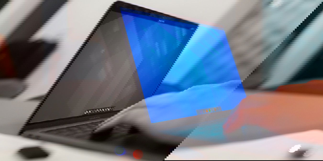 A photograph of a laptop with a GNOME desktop on its monitor.