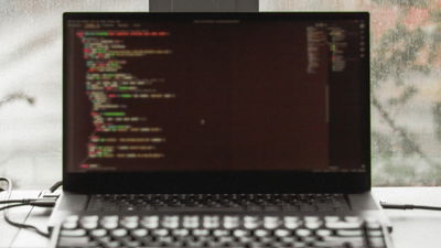 A photograph of a laptop running a terminal emulator.