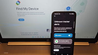 Phone with Find My Device alerts turned on sitting on a laptop.