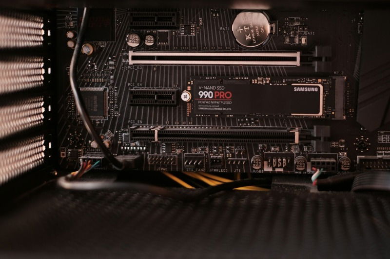 A computer motherboard showing an SSD and PCIe slots