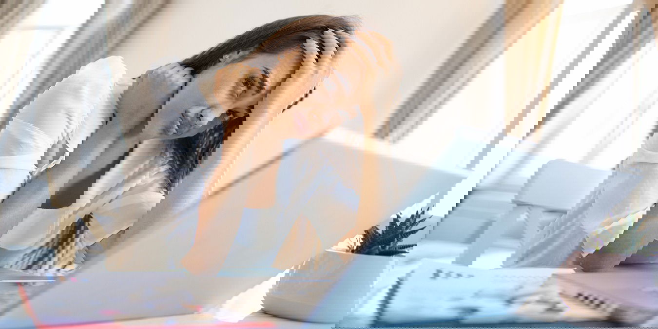 Young Frustrated Woman Working From Home Office In Front Of Laptop Suffering From Chronic Daily Headaches, Treatment Online, Appointing To A Medical Consultation, Electromagnetic Radiation, Sick Pay