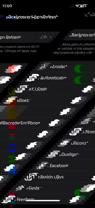 Disabling background app refresh option for select apps on iPhone.