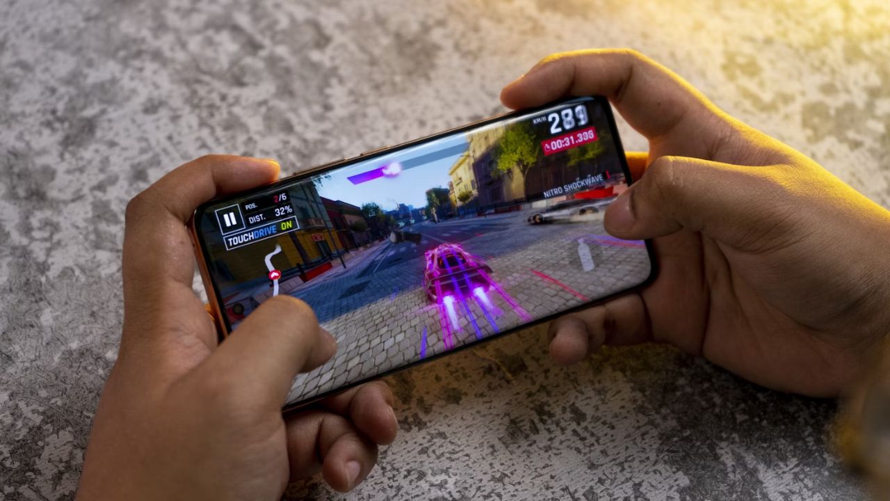 Playing a racing game on an Android phone.