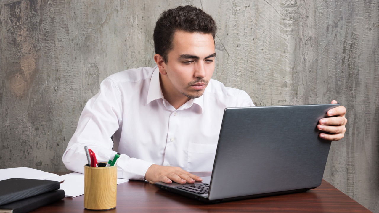 Man carefully looking at the laptop