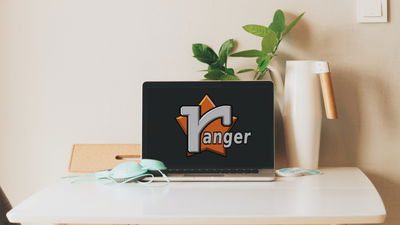 A photograph of a laptop on a dining table.