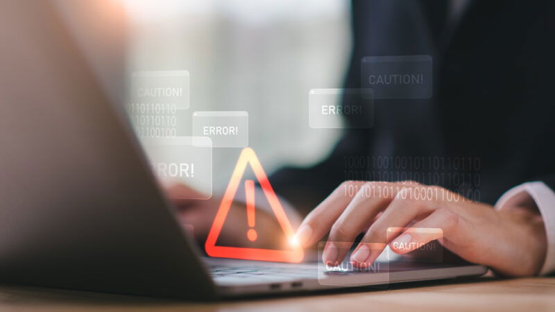 person using laptop with error signs