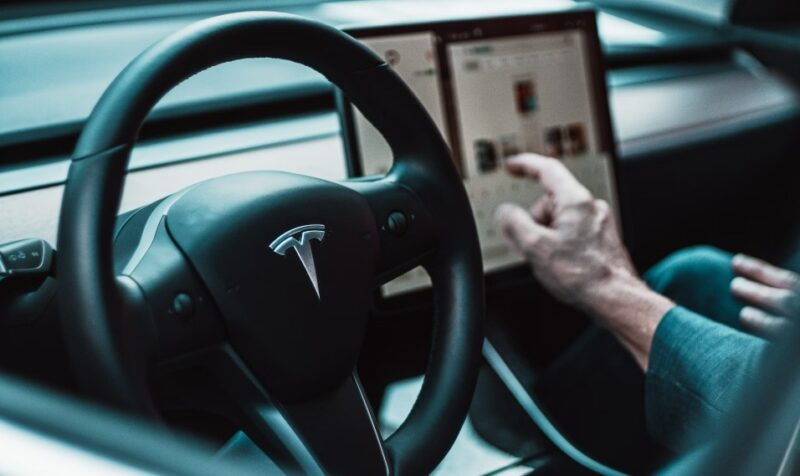 Driver behind the wheel of a Tesla.