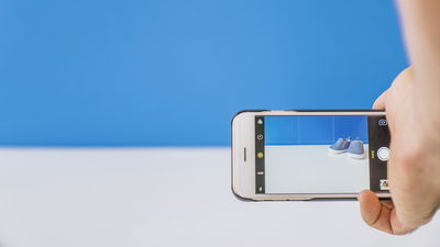 Taking picture of shoes with blue background