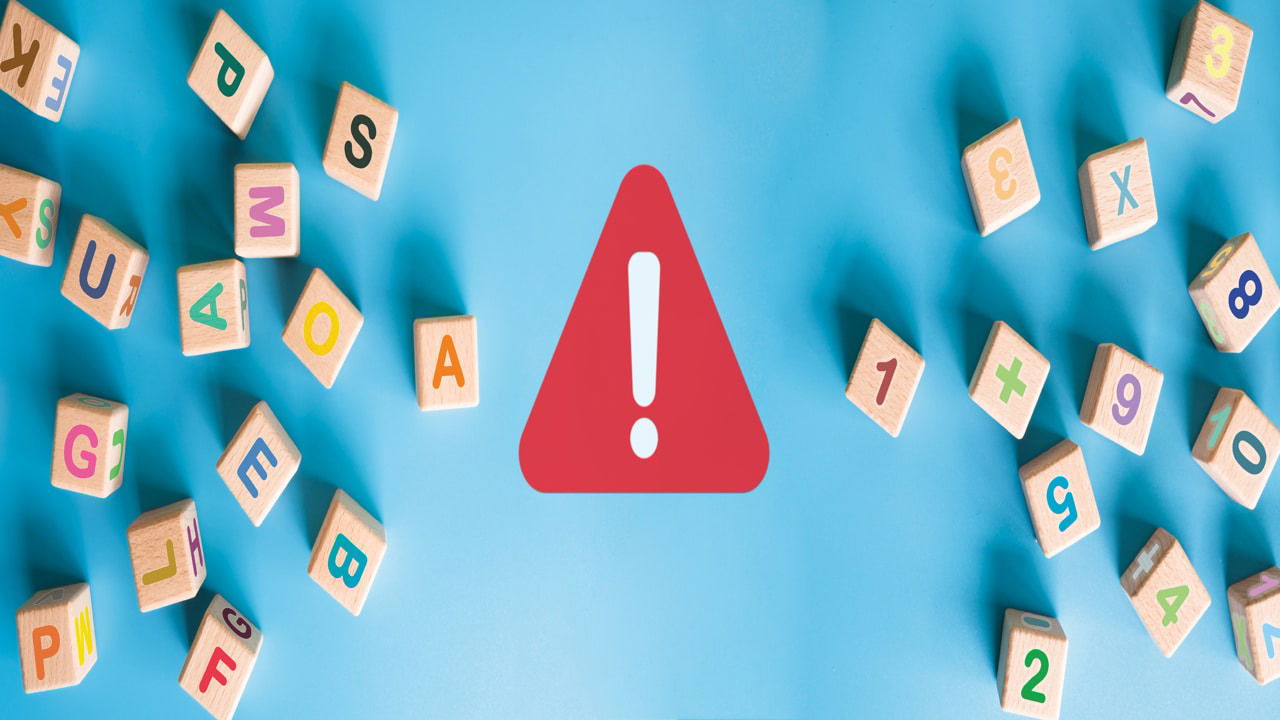 letter block on blue background with a warning sign