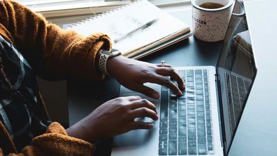 An image of a woman typing on a keyboard