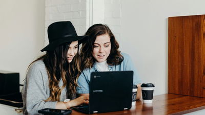 Two women working on a computer